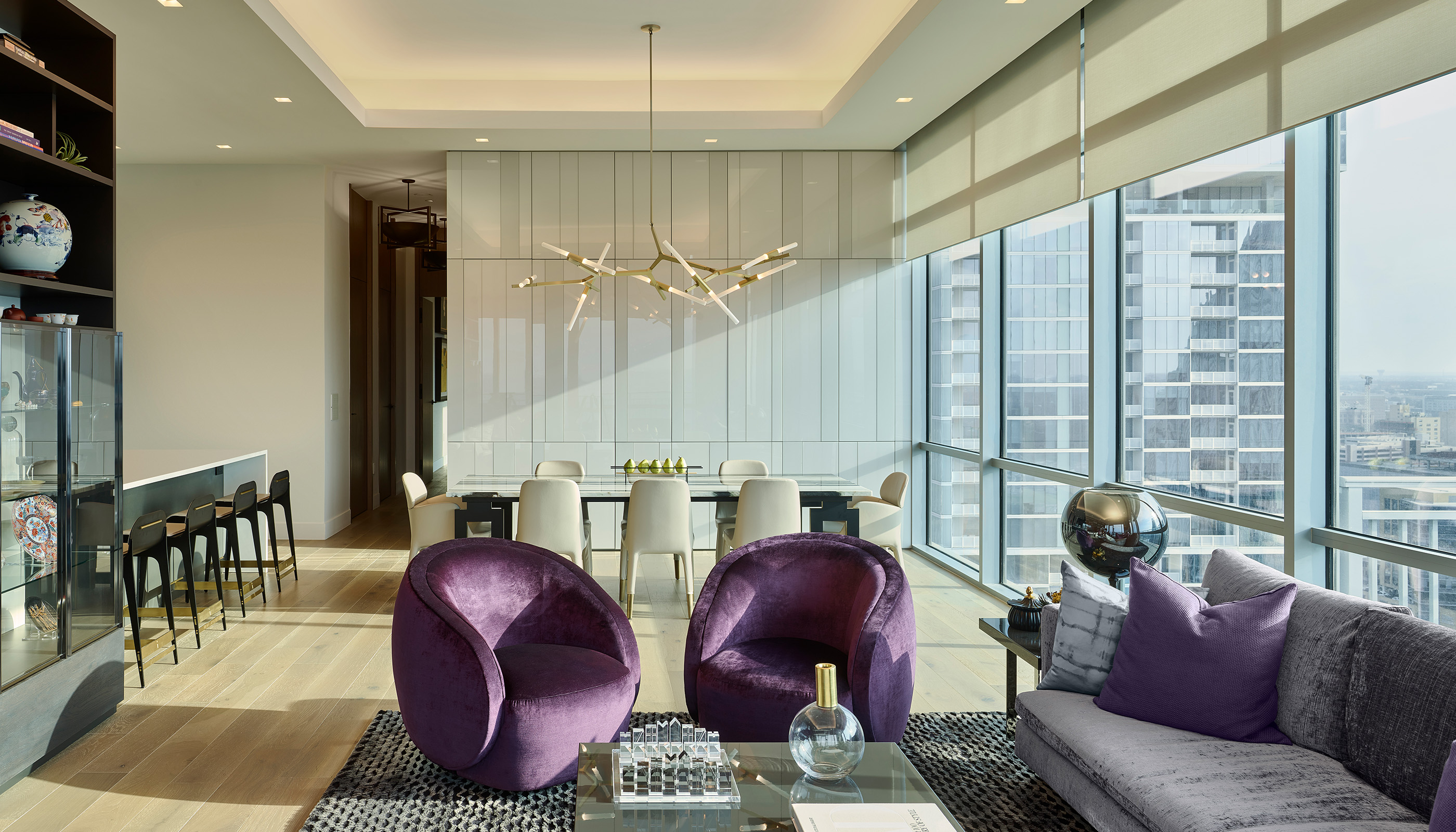 An Austin residential living room with Lutron Ketra lights, Palladiom roller shades, and HomeWorks.