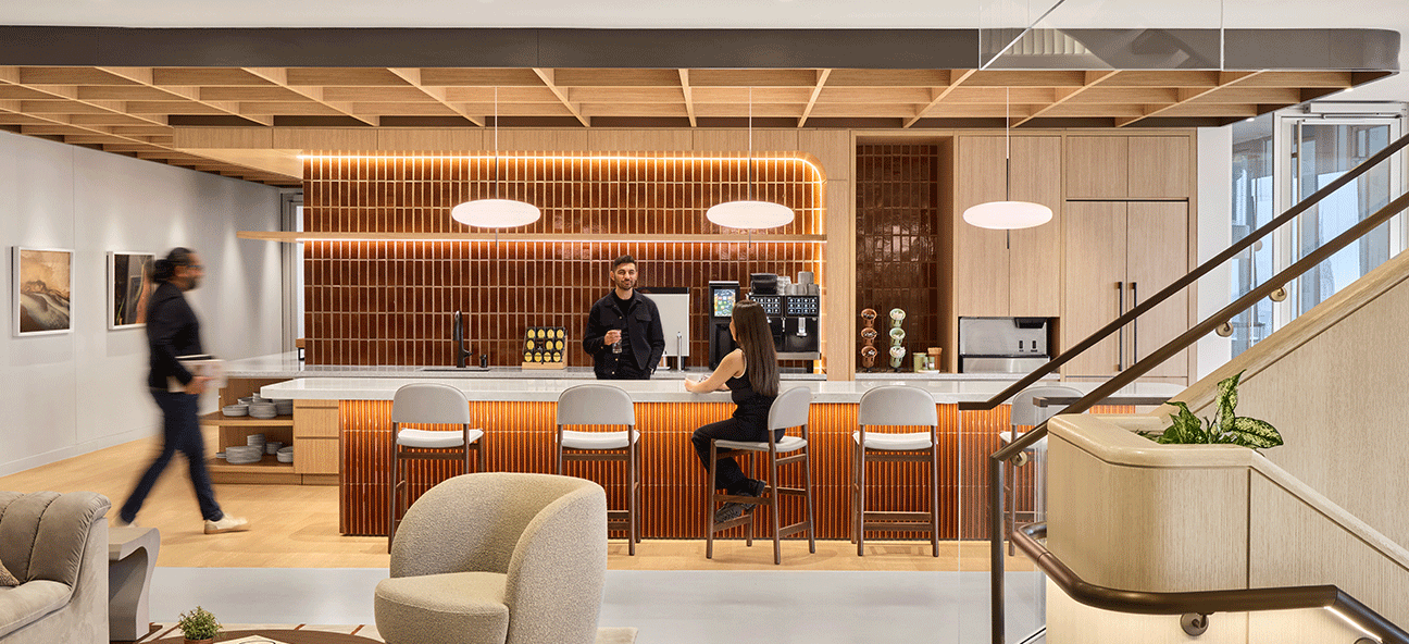 Employees gather in a community space in a modern office
