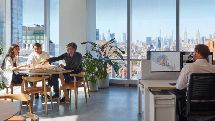 Modern open office with city views lit with tunable lighting.