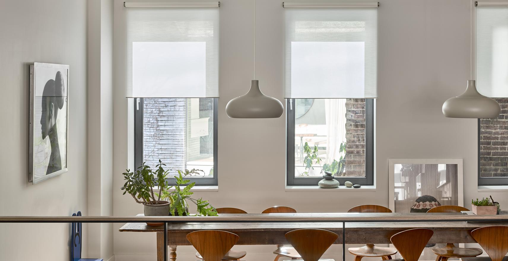 Spacious dining room with automated roller shades filtering natural light