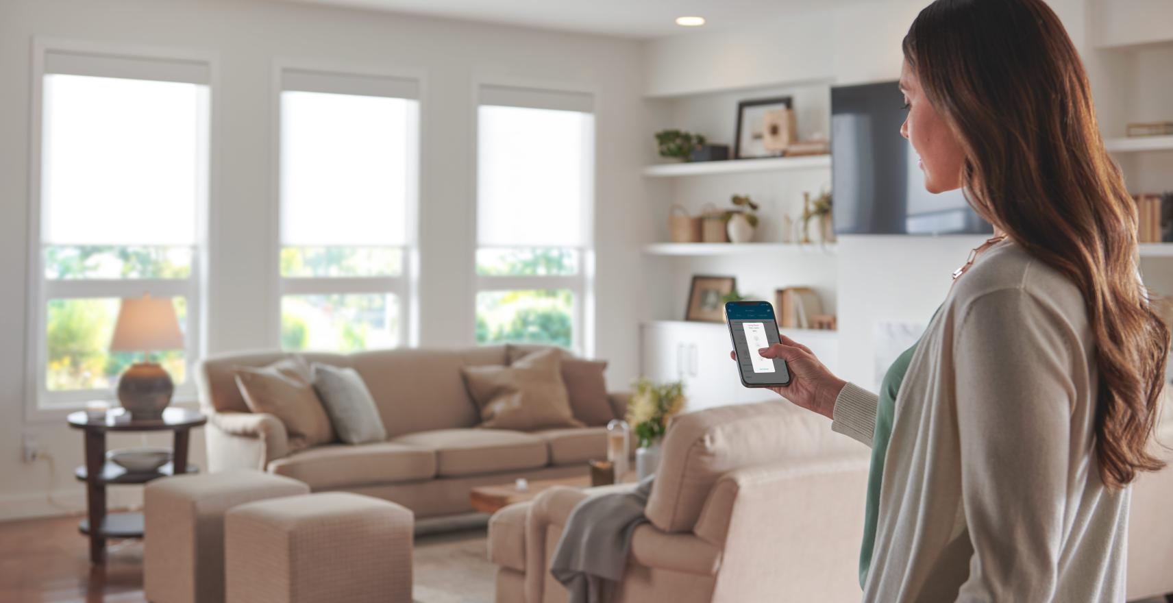A woman controls the Maestro products in her home through the mobile app.