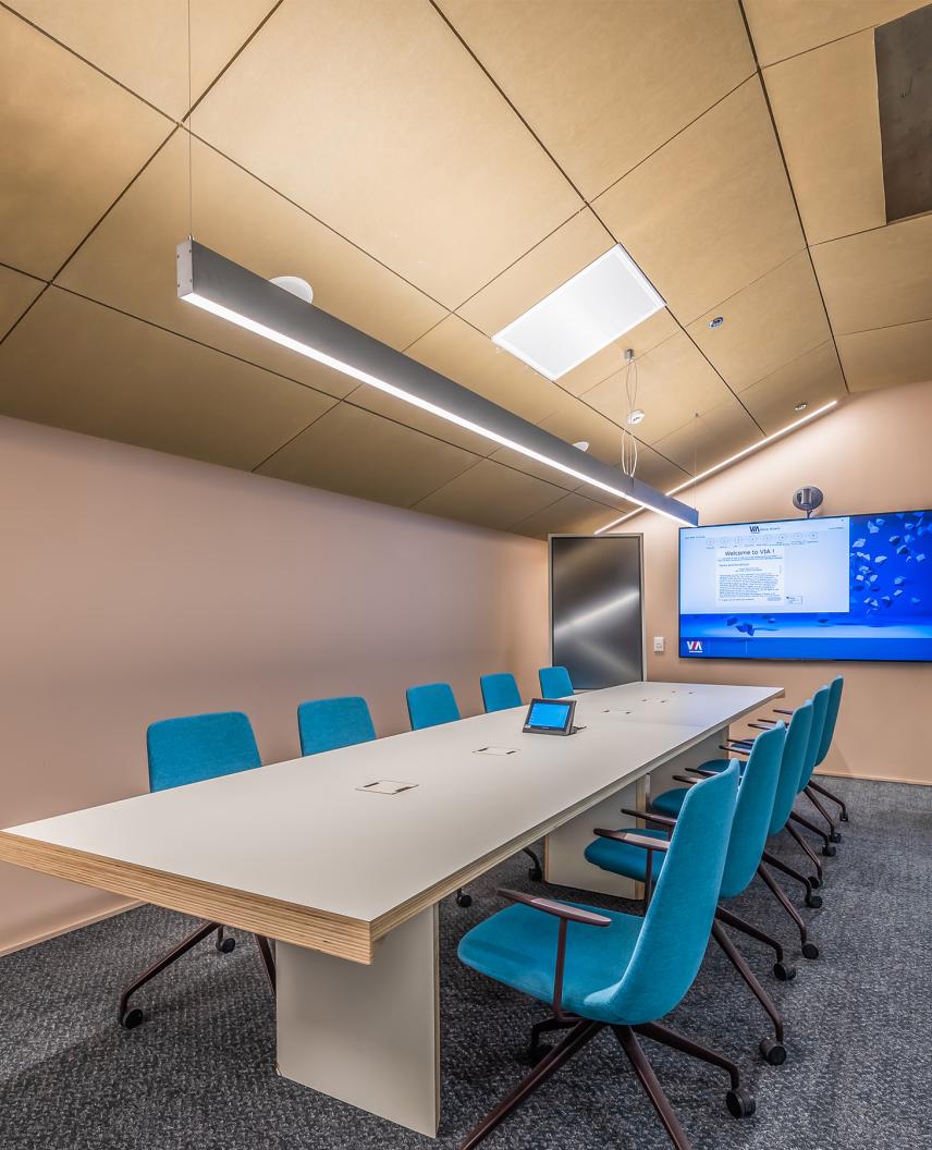  Conference room with A/V integration automatically coordinating lighting, shades, and displays for presentations 