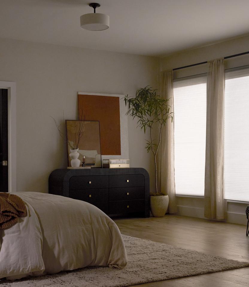 A Northeast private residence bedroom with Lutron Serena & Honeycomb Shades