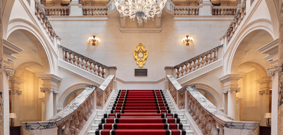 The grand staircase at the Raffles London at The OWO hotel