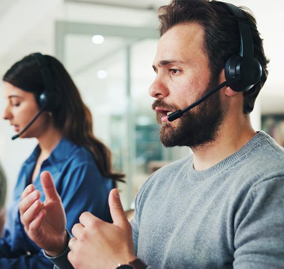A man answers a phone call from a customer
