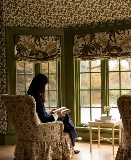 Young sitting at bedroom windows