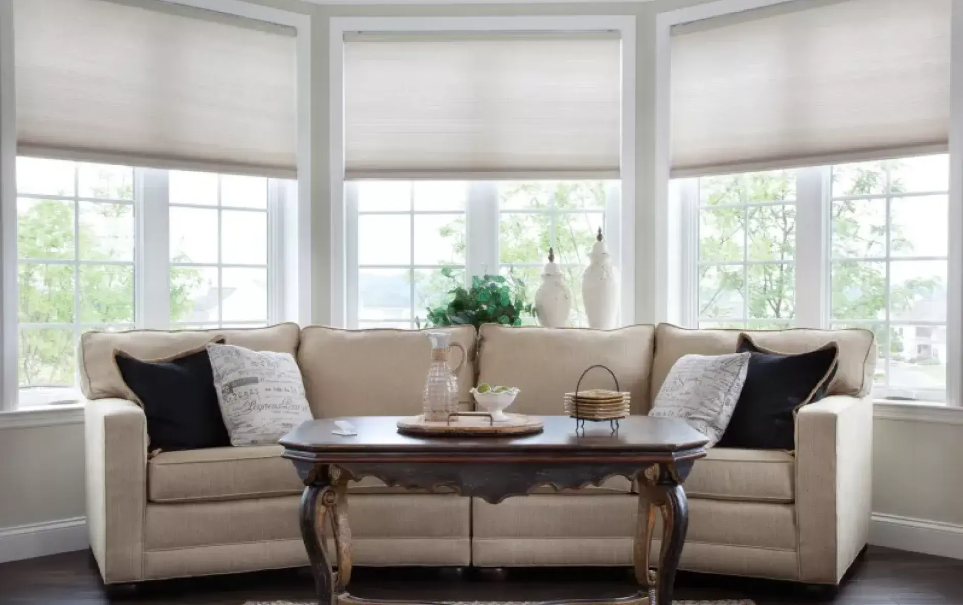 Automated cellular shades in Living room setting provide privacy while allowing natural light through light-filtering fabrics