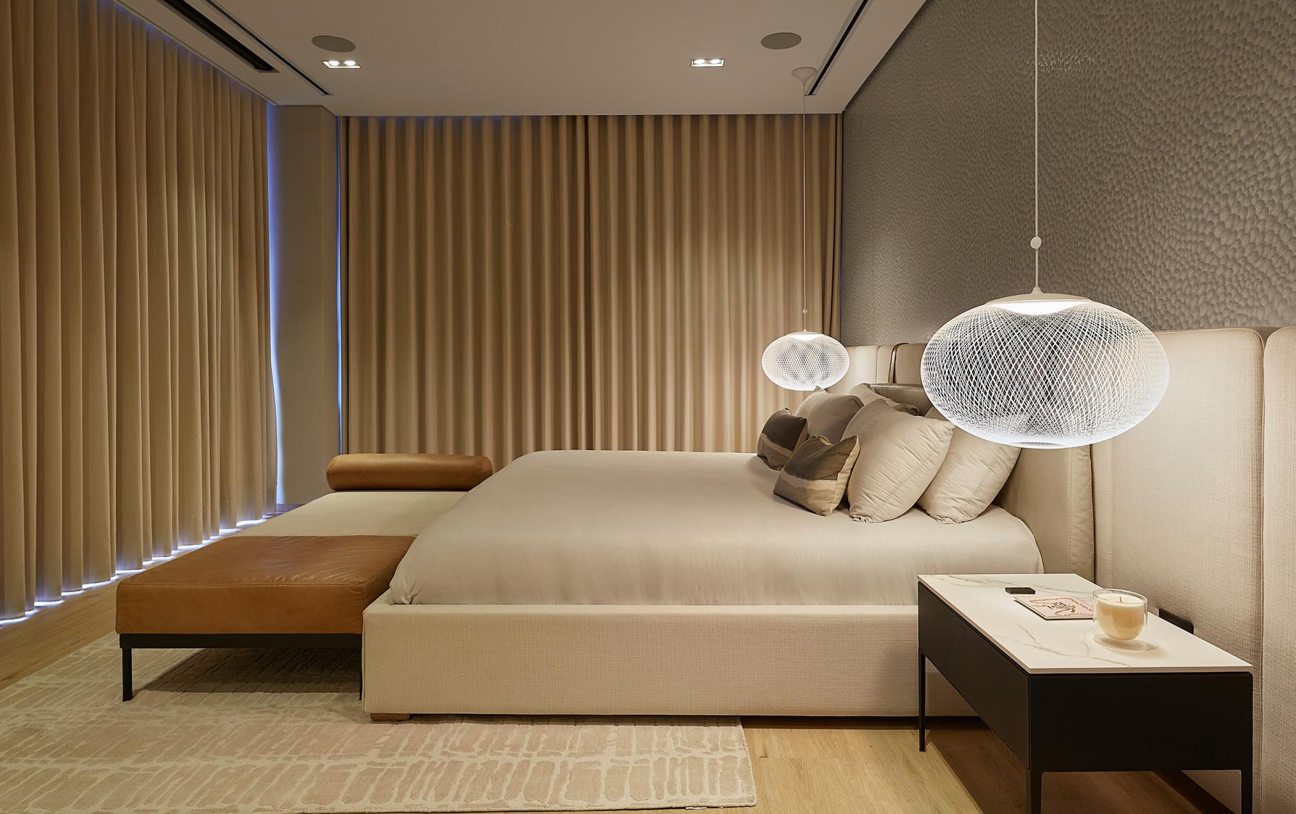 Minimalist bedroom with Lutron drapery tracks, neutral bedding, and clean architectural lines.