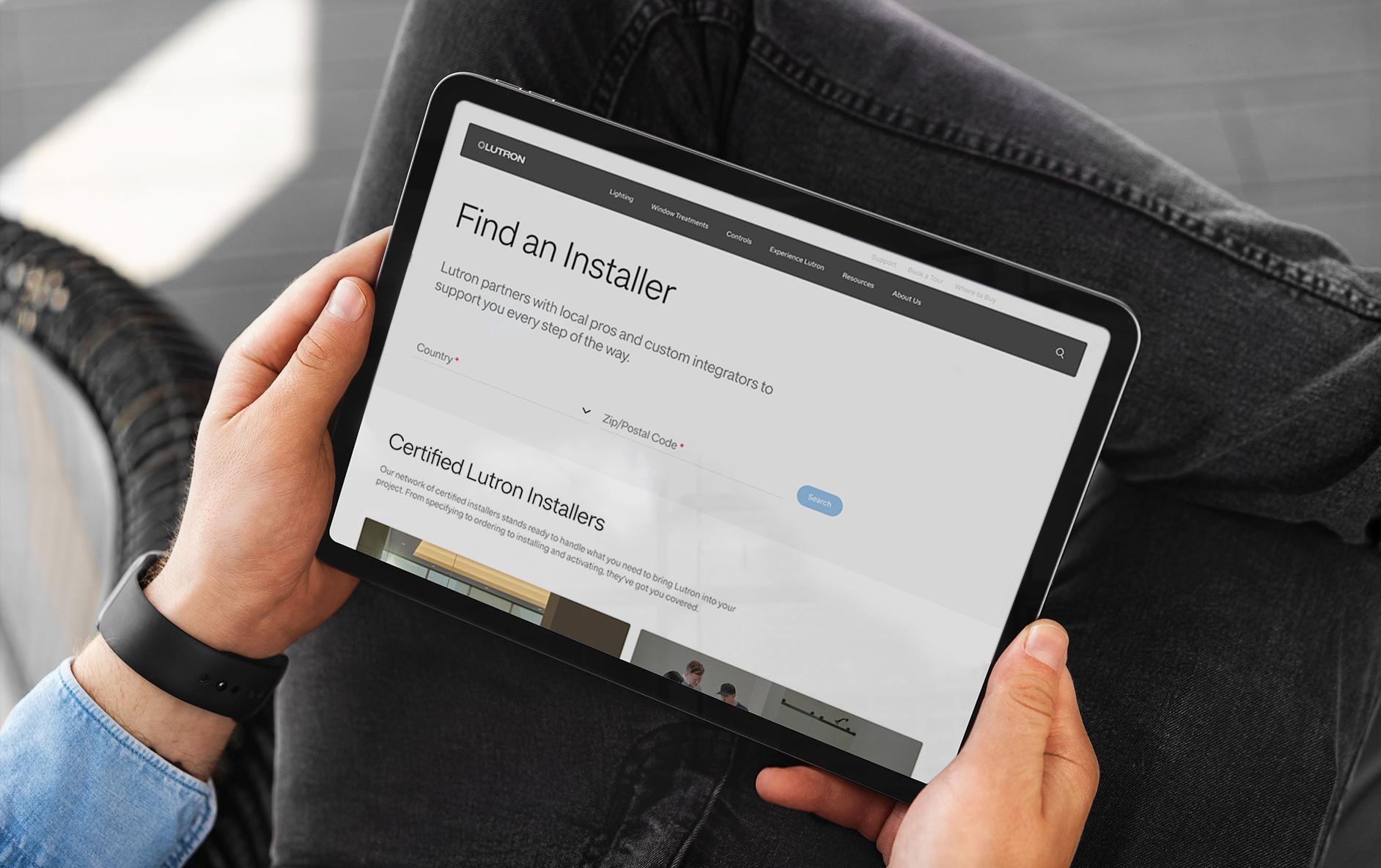 Lutron professional using Find an Installer tool via tablet.