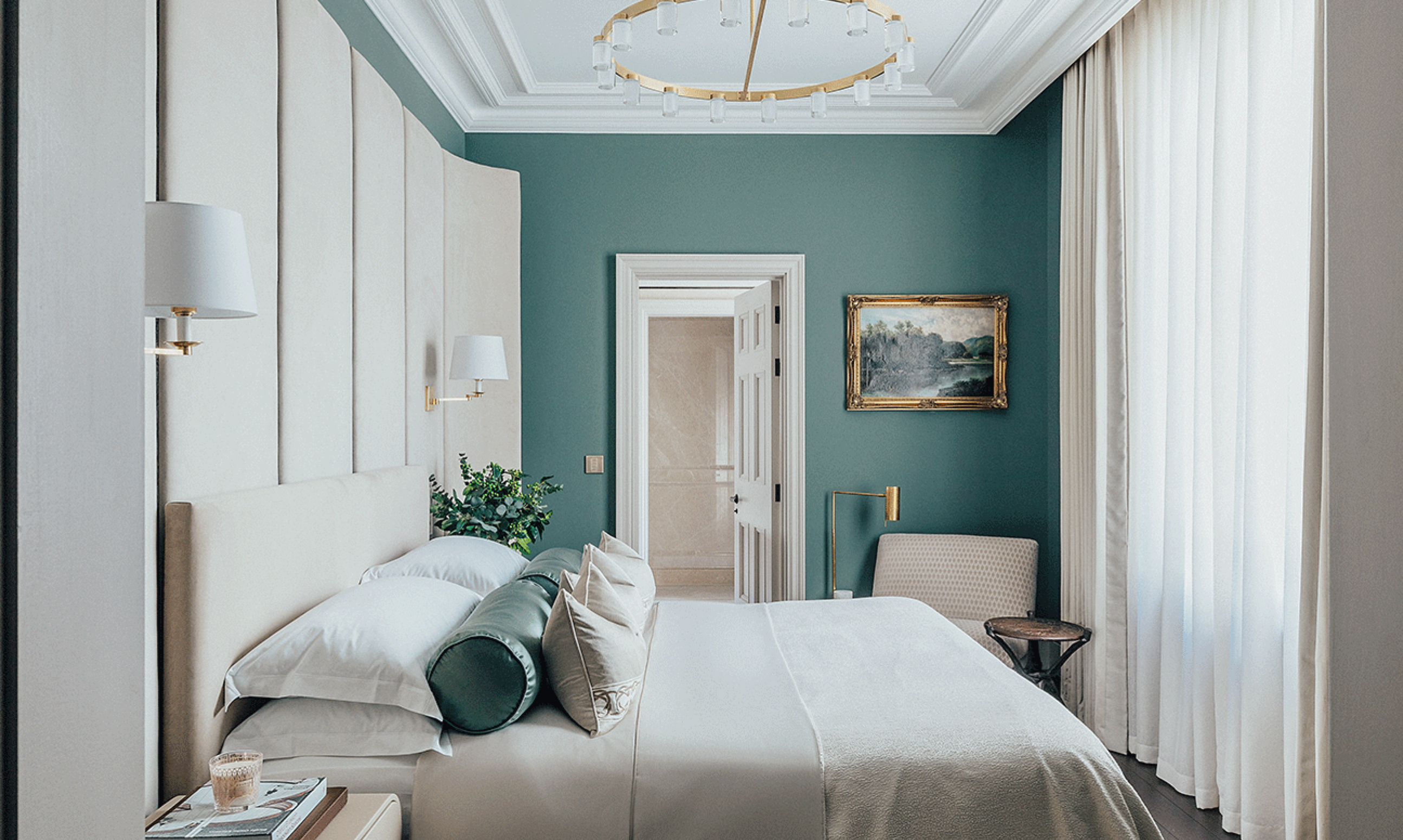 An opulent bedroom with blue walls and lutron keypads and drapes