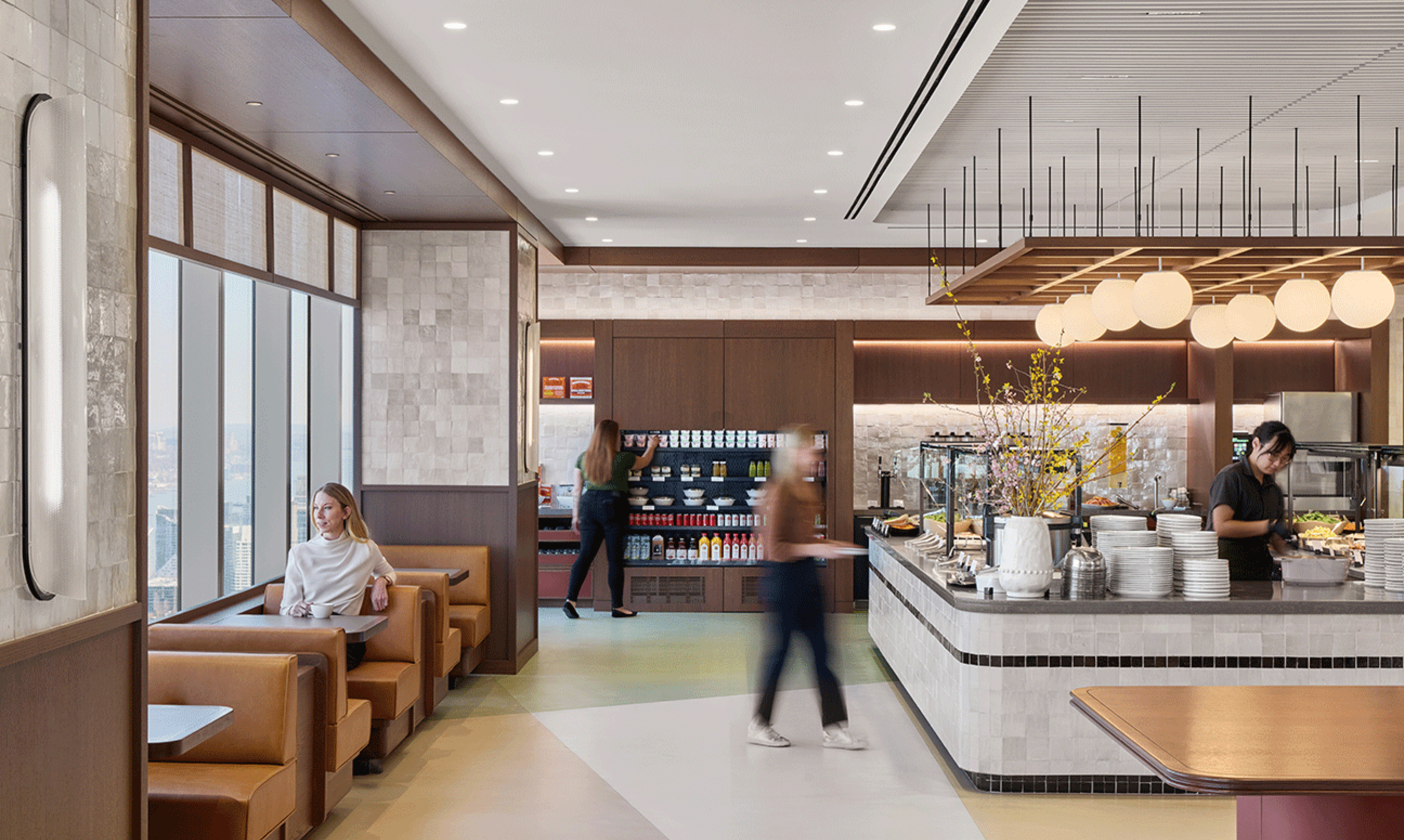 Employees enjoy a in-office cafe at a modern office building