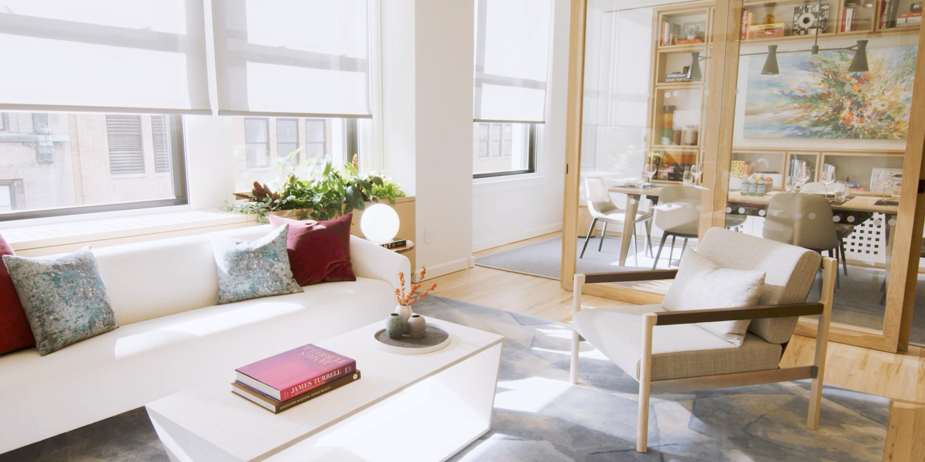 Sunlit interior with roller shades deployed three-fourths of the way down the windows.