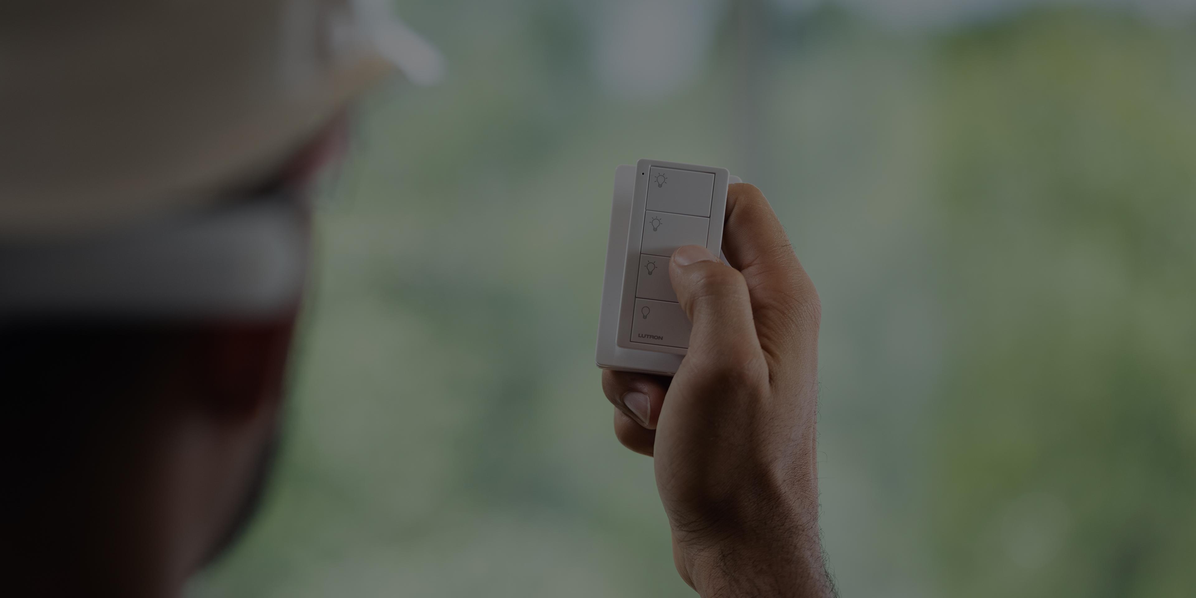 Electrical contractor holding a Pico wireless remote during a Vive installation.